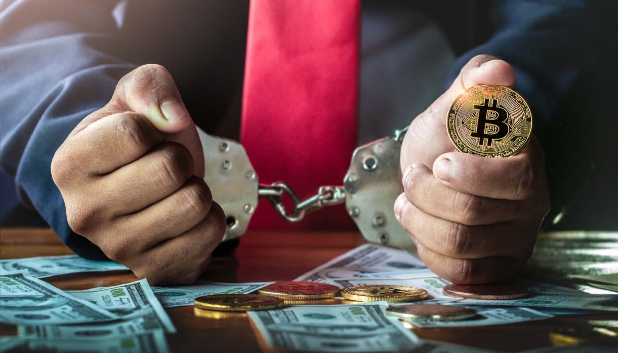 Legal Challenges in Cryptocurrency: Blockchain & Cryptocurrency Law Insights | Law Office of NiaLena Caravasos Businessman with handcuffs holding a golden bitcoin, symbolizing legal challenges in blockchain and cryptocurrency